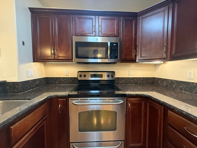 Building Photo - Upgraded Condo with Private Patio, AC, Pool, Gym, and Covered Parking in Gated Community