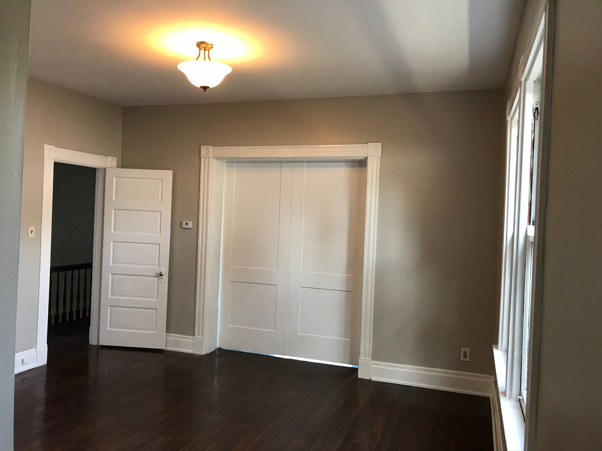 Large living room with big windows and barn doors. - 2221 Oakland Ave