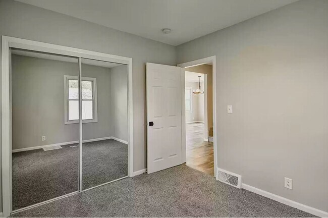 primary bedroom with new mirrored closet doors - 743 Marie Ave