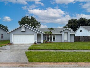 Building Photo - Spacious 3/2 with split plan and large fenced yard!