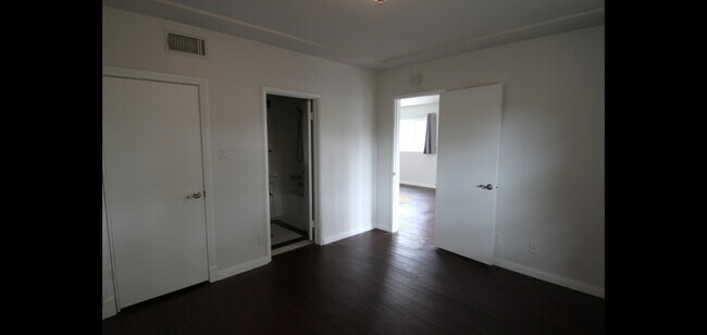 Taken from the opposite side of the bedroom looking out the bedroom door you can see the bathroom a - 14715 Addison St