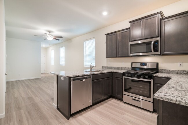 Building Photo - Super clean & spacious 4-bdrm/3-bath townhome in NE—Attached garage, great location