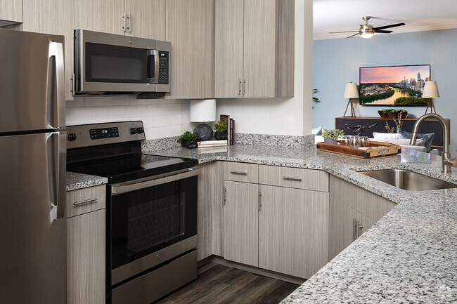 Modern kitchens with upgraded stainless steel appliances and premium granite countertops - The Madison Apartments