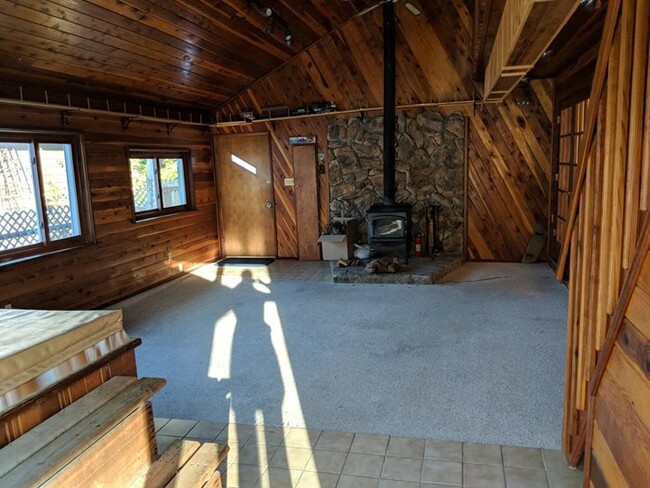 Awesome 2 season room (not well insulated) with wood burning fire place, old hot tub, and loft. Train set goes around entire room. - 28 James Circle