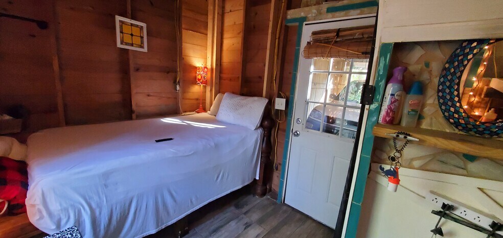 Another view of the bed with door leading to garage - 5014 Hillwood Cir S