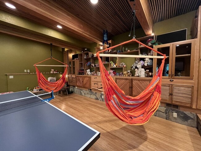 Building Photo - One-of-a-Kind Custom Home with Wall of Windows, Stone Fireplaces, Expansive Entertainment Space &...