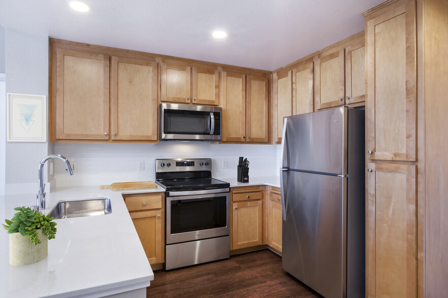 Renovated Package II Kitchen with stainless steel appliances and hard surface flooring - Avalon San Bruno