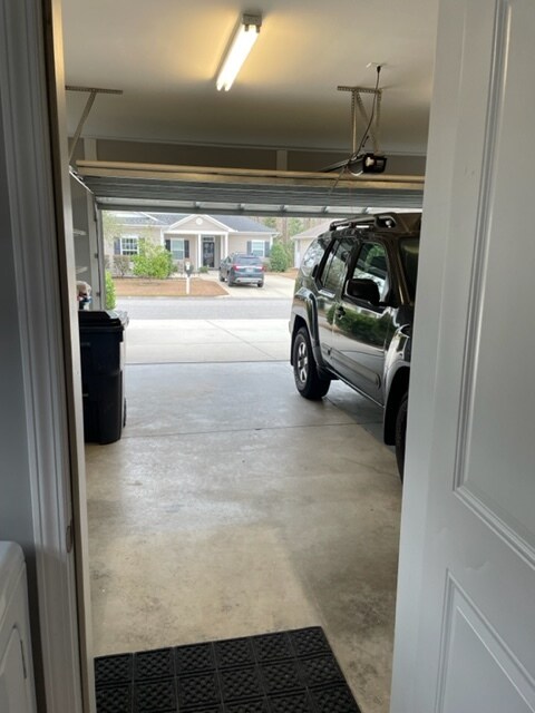 2-car garage with utility sink and shelving - 824 Wintercreeper Dr
