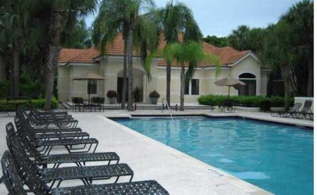 here are tables and lounge chairs around both pools. - 550 S Park Rd