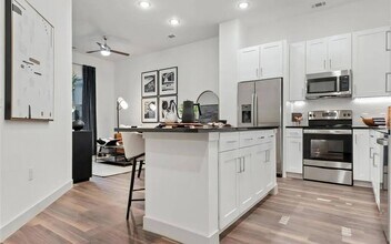 Apartment Interior with White Cabinets and Combined Living Space - The Elm at River Park