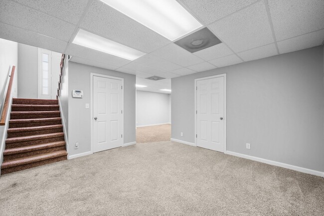 Building Photo - Stunning Stone Fireplace • Finished Basement • Fenced Yard