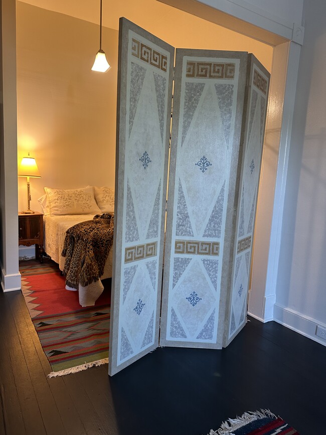 Bedroom alcove with screen separating from living area. - 1314 Pleasant St