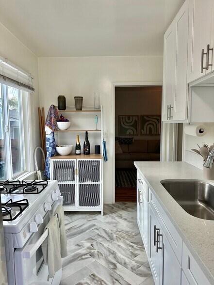 Kitchen has gas range and fridge. - 1408 18th St