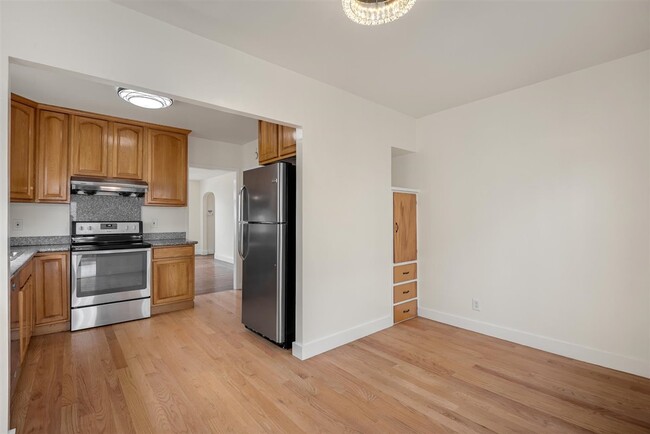 Adorable dining room allow for intimate dining above with a beautiful flush-mount chandelier. - 2108 E 23rd St