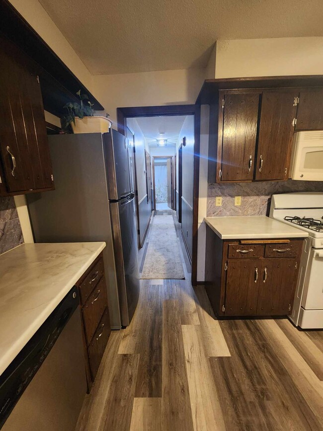 Hallway to stairwell door, bedrooms and bathroom - 4449 Unity Ave N