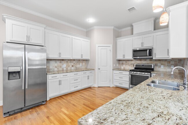 Kitchen view with large pantry behind corner door - 1221 W 23rd St