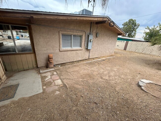 Building Photo - Single story home with large backyard and huge carport with plenty of storage.