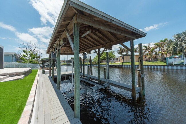 Building Photo - Live the ultimate Space Coast waterfront lifestyle at this stunning beachside canal home in Satel...
