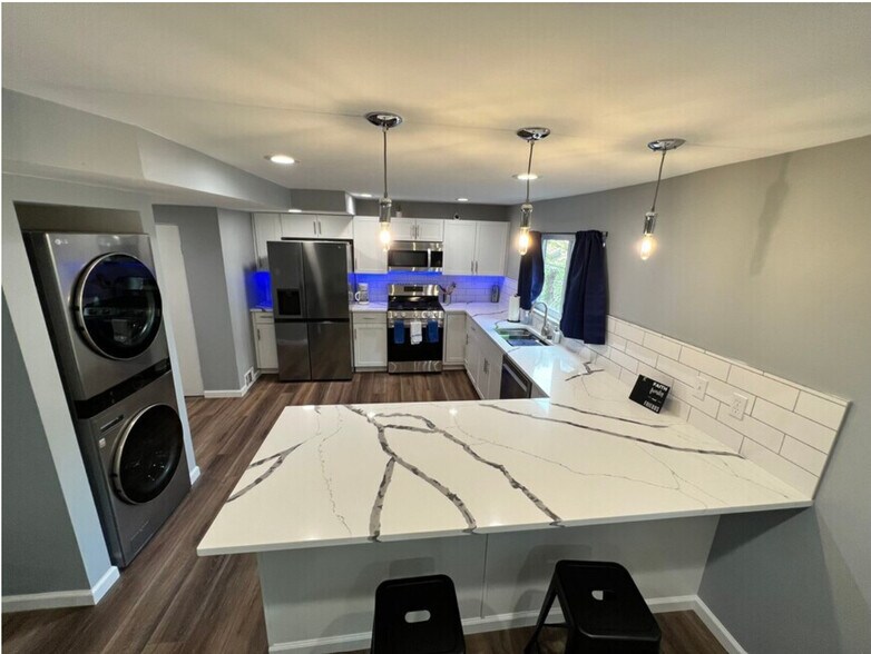 Kitchen with stainless steel appliances, generously spacious quartz countertops & peninsula - 3932 Vinceton St.