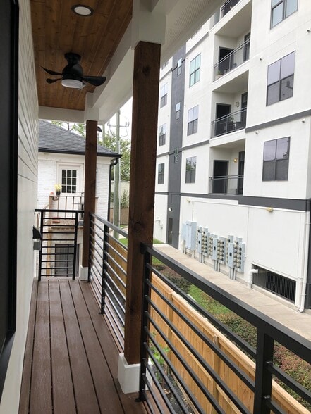 private balcony with exterior lighting and ceiling fans - 1928 Harold St