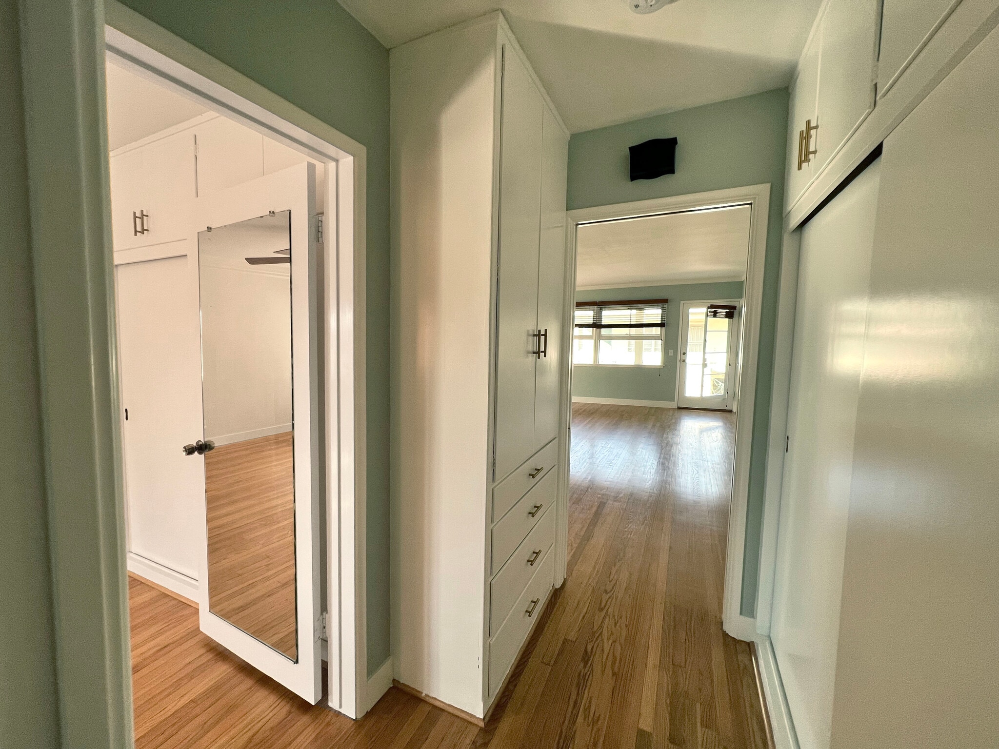 Hallway with built in storage. Bedroom to the left, living room to the right. - 1327 N Central Ave