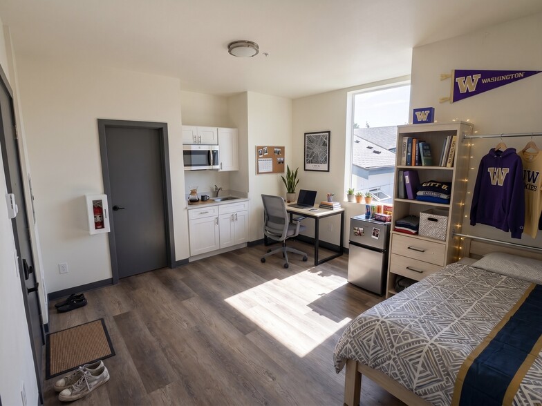 this unit comes without desk, bed, or decorations. It does have a cooktop and small fridge - 4544 20th Ave NE