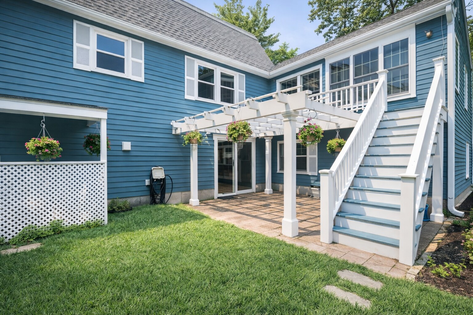 Outdoor patio area with pergola and deck, perfect for relaxing or enjoying warm weather - 16 Miller Rd
