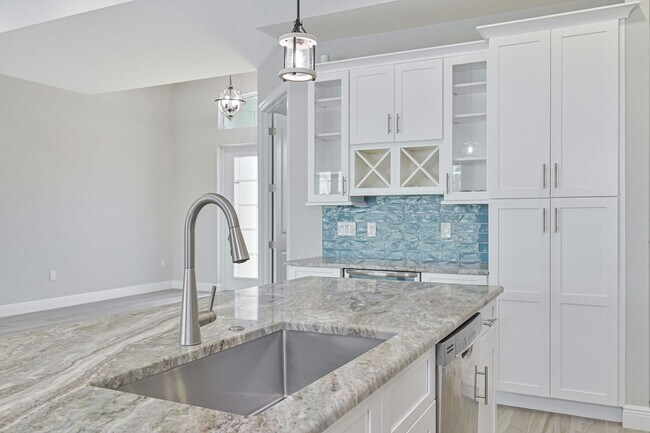 Building Photo - NOW AVAILABLE - Gorgeous Pool Home ~ NW Cape ~ 3 Car Garage ~ On Canal!