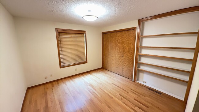 Building Photo - 4bd/3ba HUGE Home w/Hardwood Floors, Russian Fireplace, 2-Car Garage & Fenced Back Yard!