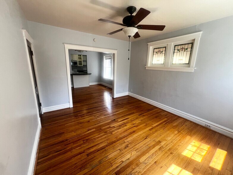 Living room with plenty of natural light and historic 1920's stained glass. - 2107 Maury Ave