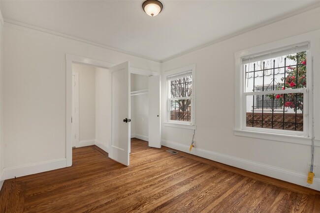 Main bedroom with two large windows and walk in closet. This master has two entrance and exits. - 2108 E 23rd St