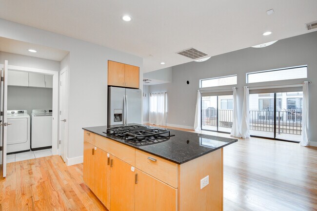 Another view of main floor with door to pantry, laundry room and spacious deck pictured. - 4202 Spencer St