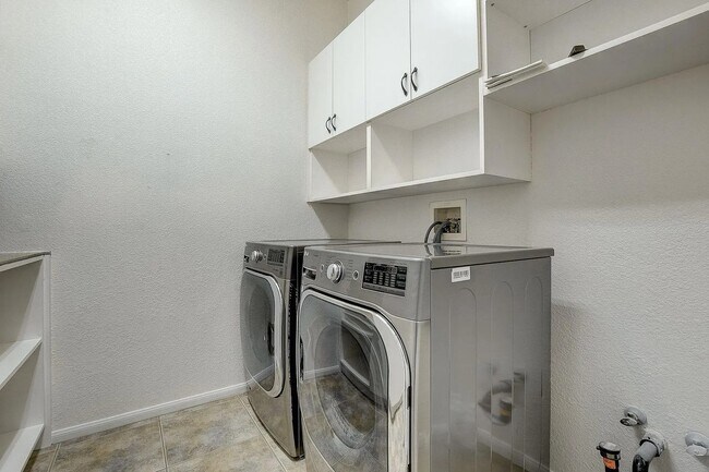 Large Washroom with washer dryer with large custom storage closets - 3034 Constable St
