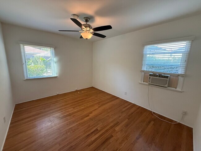 Bedroom with ceiling fan light. - 1755 Silver Lake Blvd
