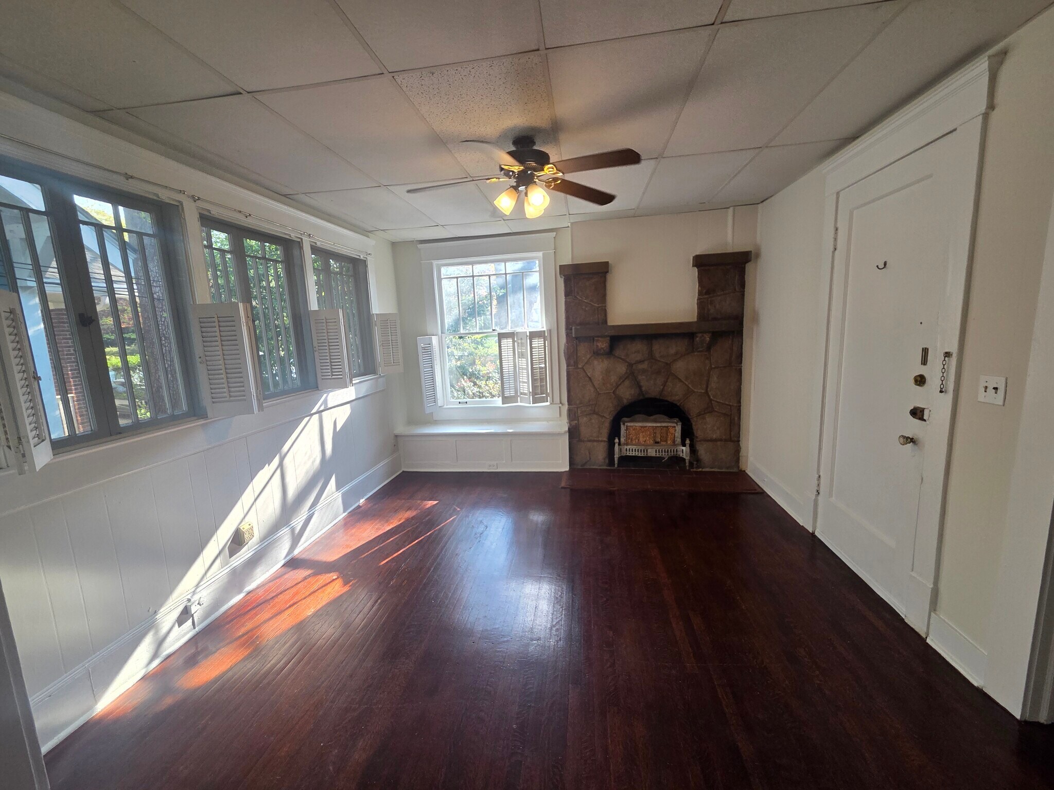 Living Room with bench seating, mantle, and lots of windows - 974 N Highland Ave NE