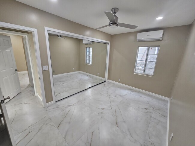 Room 2 largest closet space, ceiling fan, and AC. - 918 E Elk Ave