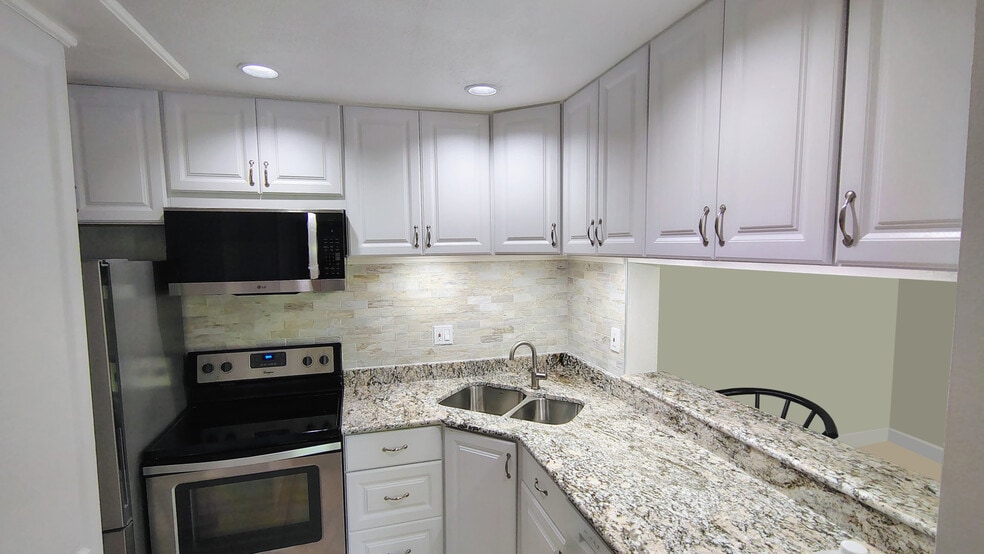 2026 remodeled kitchen with granite countertops, SS appliances, special lighting accents - 1353 Pine Ridge Cir E