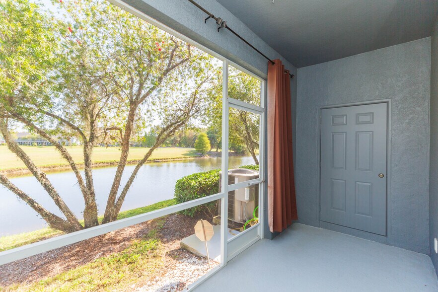 Covered, screened lanai with 2x6 storage closet and view of pond/golf course - 18135 Nassau Point Dr