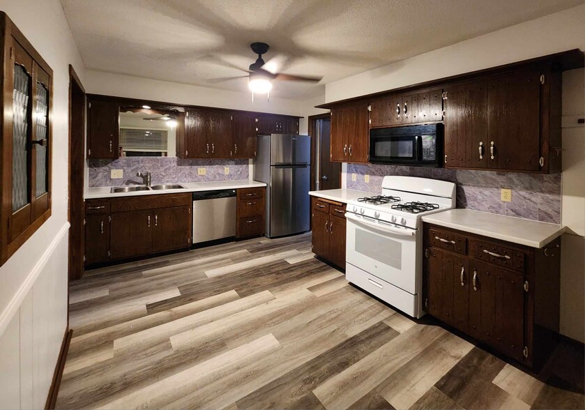 Kitchen with new ceiling fan, wall spice cabinet - 4449 Unity Ave N