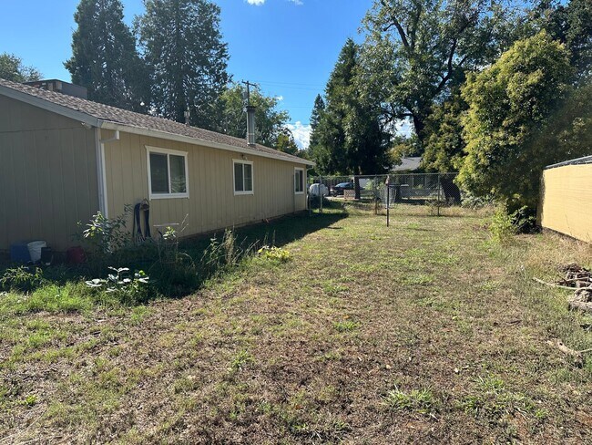 Building Photo - Charming Redding Home with Fireplace & Vau...