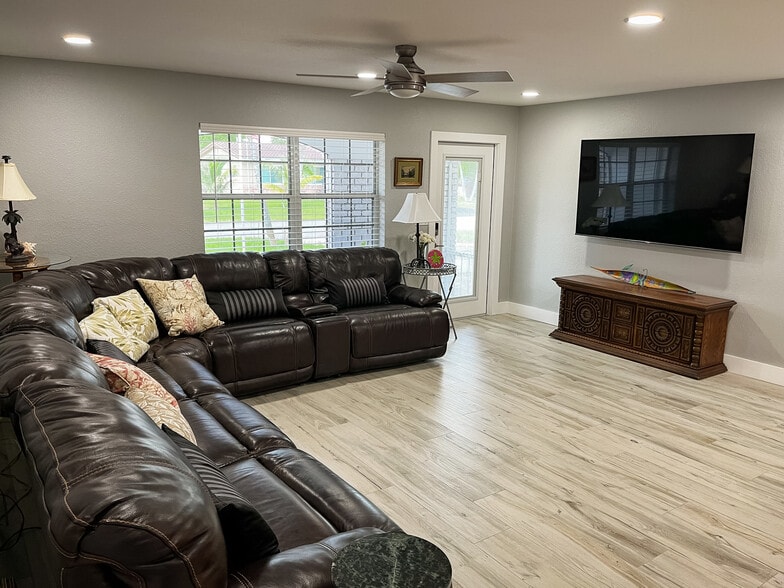 Living Room - Leather Couch (3 seats recline) with 75" TV with Complimentary Cable & Netflix - 4540 NW 12th Dr