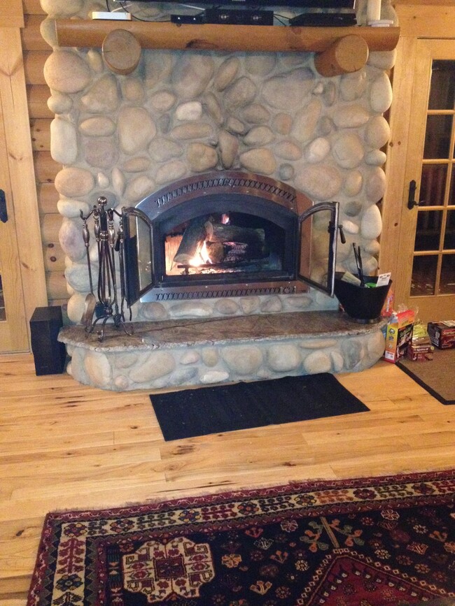 Stone fireplace equipped with a heat recirculating system to save on heating costs! - 135 Song Mountain Dr