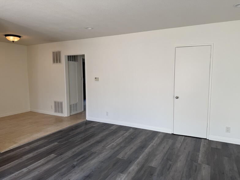 Living room with closet door, dining room and hallway to the bedroom and bathroom - 5462 Barton Ave