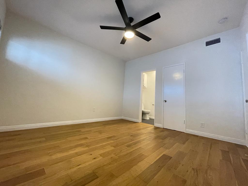 main bedroom with attached half bath and walk in closet - 7855 W Manchester Ave