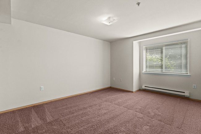 A comfortable bedroom retreat with plenty of space to relax and unwind. - Villas at Lawrence