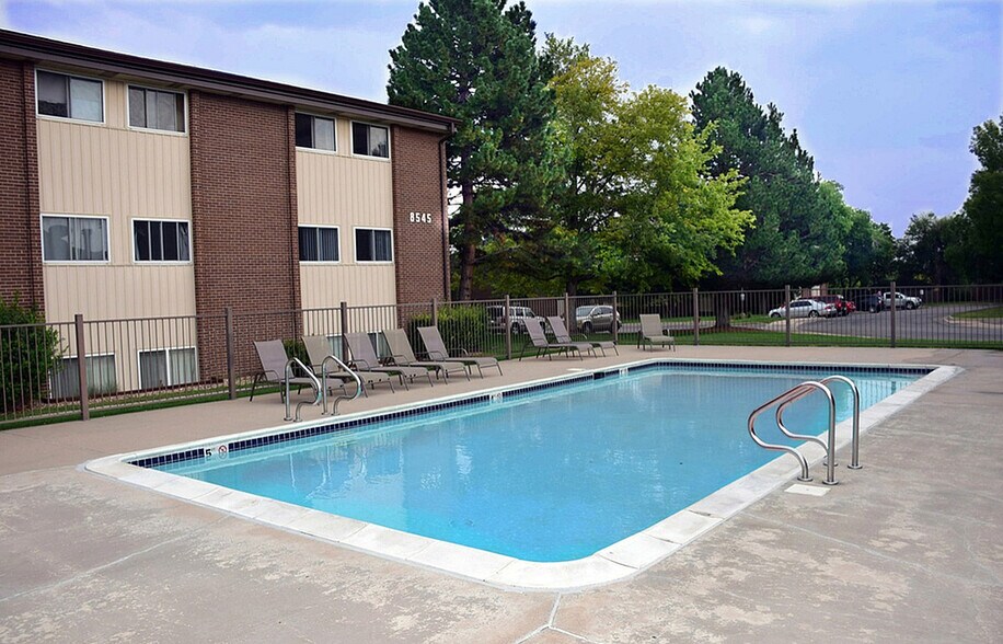 Relax by the sparkling pool in our residential community, perfect for leisure and enjoyment. - PINETREE Apts
