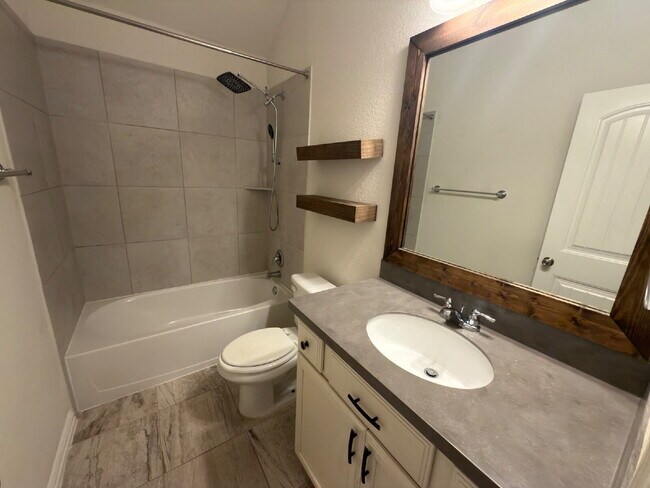 Building Photo - Four bed two bath on a corner lot with a pool in Sunfield. Gas cook top, double ovens. Open kitch...