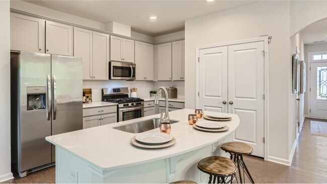1st floor kitchen: Sleek, functional, culinary inspiration awaits within these contemporary walls. - 13119 Cottage Crest Ln
