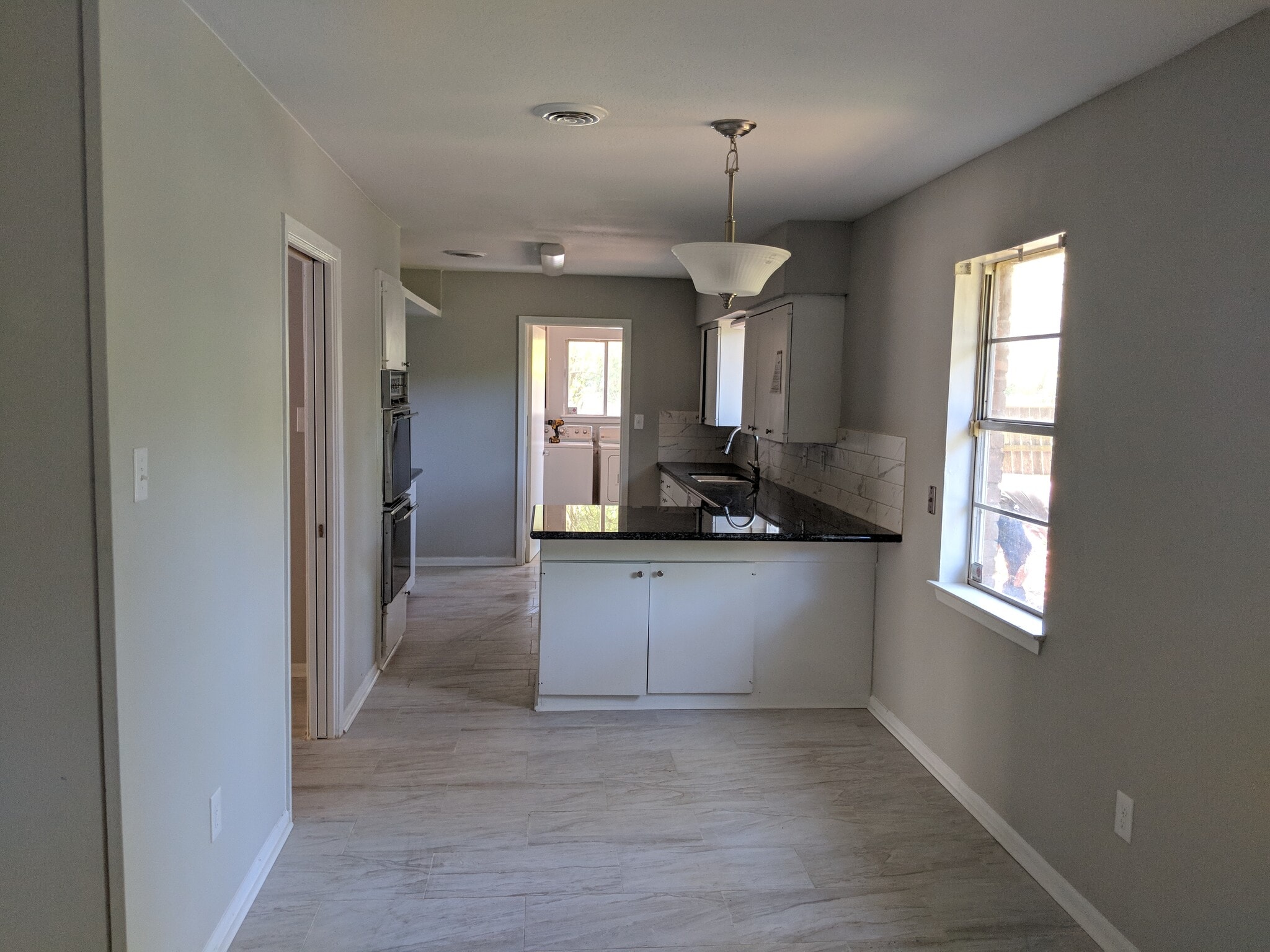 Breakfast area leading to the kitchen, utility room with washer and dryer to the back - 5478 Birdwood Rd