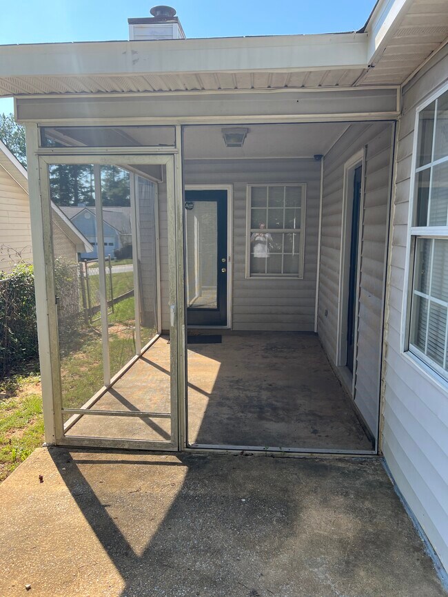 Patio with entrances to living room and master bedroom. - 32 Lexington Cir